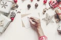 Child writes letter to Santa Claus top view. kid hands holding p Royalty Free Stock Photo