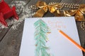 Child writes letter to Santa and draw a Christmas tree. Royalty Free Stock Photo