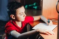 Child writes in a notebook