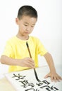 A child writing Chinese Calligraphy