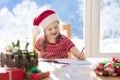 Child writing letter to Santa. Present wish list Royalty Free Stock Photo