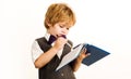 Child writing in notebook. Schoolboy in school uniform. Back to school. Royalty Free Stock Photo