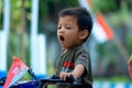 the child& x27;s expression when yawning on a bicycle Royalty Free Stock Photo