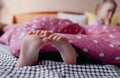 child's feet sticking out from under the blanket