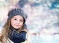 Child's girl portrait on blurred winter background.