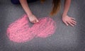 child& x27;s hand draws hearts, drawings chalk on asphalt Royalty Free Stock Photo