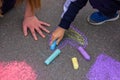 child's hand draws hearts, drawings chalk on asphalt Royalty Free Stock Photo