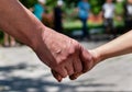 Child& x27;s hand in hand of elderly woman in sunlight Royalty Free Stock Photo