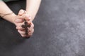 Child& x27;s hands clasped in prayer and holding the wooden cross on dark background. Royalty Free Stock Photo