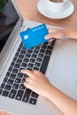Child& x27;s hands holding credit card and typing on keyboard Royalty Free Stock Photo