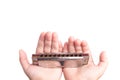 Child's hands holding harmonica isolated on white