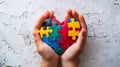 Child& x27;s hands holding a multicolored ball made up with puzzle pieces on dark blue background. Royalty Free Stock Photo