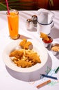 Child's meal of chicken tenders, french fries, and ketchup, with colorful crayons on the table Royalty Free Stock Photo