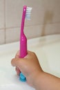 A toothbrush in the child's hand