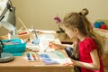The child is 7 years old, draws watercolor at the table at home. Royalty Free Stock Photo