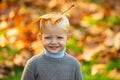 Child with yellow leaf in autumn park. Cute little boy enjoy autumn nature has happy face. Child portrait. Smile kids Royalty Free Stock Photo