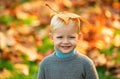 Child with yellow leaf in autumn park. Cute little boy enjoy autumn nature has happy face. Child portrait. Smile kids Royalty Free Stock Photo