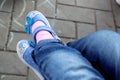 small child sitting cross-legged in blue jeans