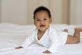 Childcare Concept. Adorable Little African American Baby Crawling On Bed At Home Royalty Free Stock Photo