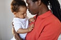 Childcare Concept. Loving Black Father Holding His Cute Baby Son In Arms Royalty Free Stock Photo