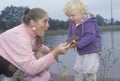 A childcare worker playing with children by a lake, Washington D.C.