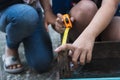 The childens is repairing wooden with a pencil and tape measure Royalty Free Stock Photo