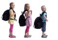 Childeren in a row with backpacks Royalty Free Stock Photo