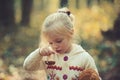 Childhood activity and active rest outdoor. Child with fresh mushroom in autumn forest. Little girl harvest mushrooms in