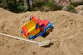 Childhood and adult life: a junk truck and a real shovel on a pile of sand Royalty Free Stock Photo