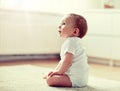 Happy baby boy or girl sitting on floor at home Royalty Free Stock Photo