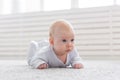 Childhood, babyhood and people concept - little baby boy or girl crawling on floor at home Royalty Free Stock Photo