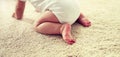 Little baby in diaper crawling on floor at home Royalty Free Stock Photo