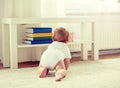 Little baby in diaper crawling on floor at home Royalty Free Stock Photo