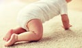 Little baby in diaper crawling on floor at home Royalty Free Stock Photo