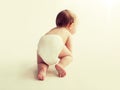 Little baby in diaper crawling on white floor Royalty Free Stock Photo