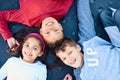 Childhood bliss. Portrait of three young siblings playing together at the park. Royalty Free Stock Photo