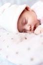 Childhood, care, motherhood, health concepts - Close up Little peace calm newborn baby girl in pink hat sleeps resting take deep Royalty Free Stock Photo