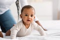 Cute little African American baby crawling in bed Royalty Free Stock Photo