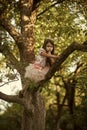 Childhood. Child climb tree branch in summer garden, secret or silence Royalty Free Stock Photo