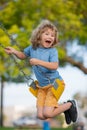 Childhood. Child on swing playing on outdoor playground. Child boy exercise at playground. Cute kid having fun on a