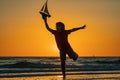 Childhood concept. Kid boy holding tou boat. Cute little blond boy put toy boat in the sea water waves at the beach on Royalty Free Stock Photo