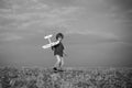 Childhood on countryside. Pilot aviator child with a toy airplane plays on summer nature. Boy with plane on meadow Royalty Free Stock Photo