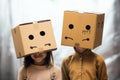 Childhood creativity two little girls wearing cardboard boxes on heads