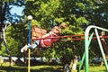 Childhood daydream .teen freedom. Small kid playing in summer. Playground in park. Happy laughing child girl on swing Royalty Free Stock Photo