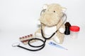 Childhood diseases concept, a teddy hippo with means for treatment fever, pain flu cough and sore throat