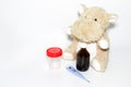 Childhood diseases concept, a teddy hippo with means for treatment fever, pain flu cough and sore throat, copy space