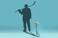 Childhood and dream about big and famous future. Conceptual image with boy and shadow of fit male hockey player on blue