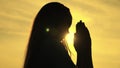 childhood dream of a happy childhood, silhouette of a teenager asking for help from God at sunset, praying for health at