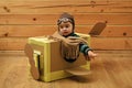 Childhood dream imagination concept . Little cute boy playing with a cardboard airplane. Royalty Free Stock Photo