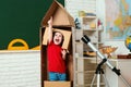 Childhood Dreams of space. Child in astronauts costumes with toy rocket playing and dreaming of becoming a spacemen. Royalty Free Stock Photo